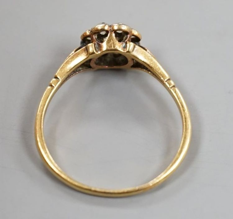A yellow metal and nine stone diamond set flower head cluster ring, size Q